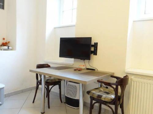 a desk with a computer monitor on top of it at Apartments FABRKA in Ljubljana