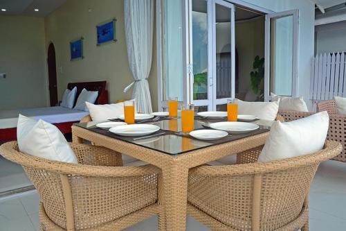 a dining room table and chairs with a table and chairs at Kokari Guesthouse in Port Blair