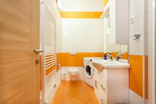 a bathroom with a washing machine and a sink at Apartments FABRKA in Ljubljana