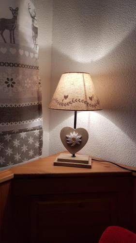 a lamp on top of a wooden table at Casa di Chiara in Padola