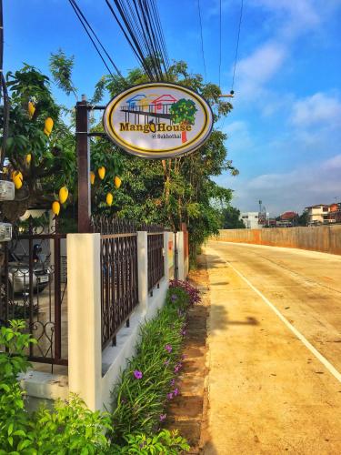 a sign for a marvellous restaurant on the side of a road at Mango House in Sukhothai