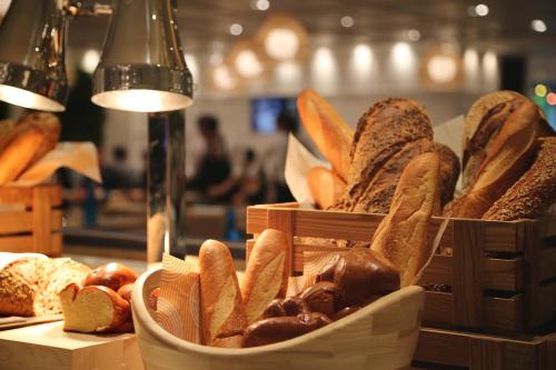 two baskets filled with different types of bread on a counter at Romance Alexandria Hotel in Alexandria