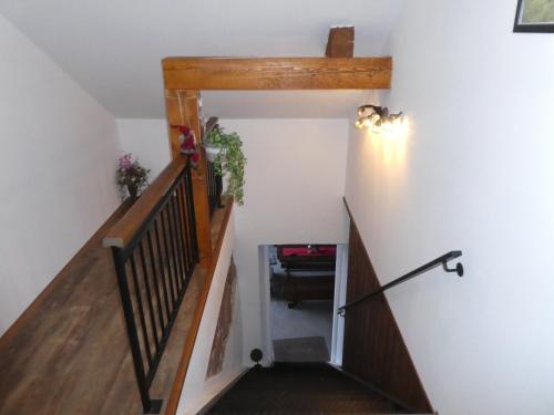 a stairwell in a house with a wooden staircase at Ubytování Farma U sv. Jakuba in Dolní Lánov