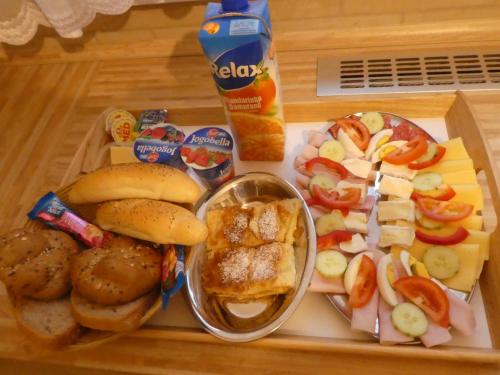 a tray of food with sandwiches and cheese and snacks at Ubytování Farma U sv. Jakuba in Dolní Lánov