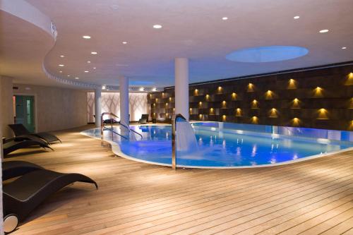 a large swimming pool in a hotel room at Hotel Reale in Lurisia