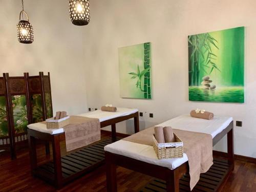 a room with two beds and two chairs at Ayana Sea in Wadduwa