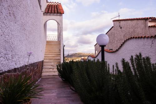 a stairway leading up to a building with an arch at Casa sui Tetti in Ozieri