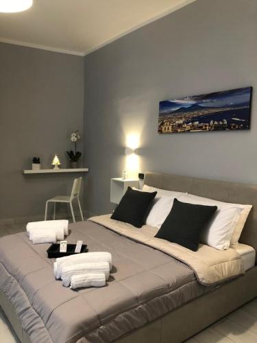 a large bed with white pillows in a room at B&B Belvedere Partenopeo in Naples