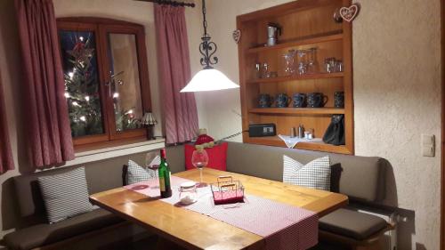 a dining room table with a bottle of wine on it at Villa Casa in Bad Tölz