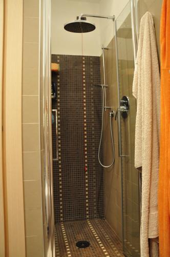 a bathroom with a shower with a glass door at Una spettacolare vista mare - Casa con Jacuzzi in Bergeggi