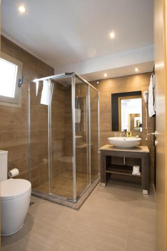 a bathroom with a shower and a sink at Aqua Oliva Resort Syvota in Syvota