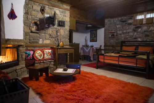 a living room with a bed and a fireplace at Spitiko in Kato Loutraki