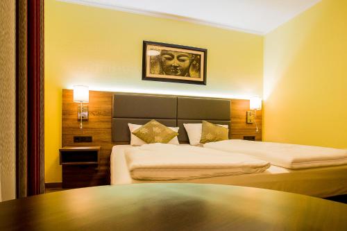 Cama o camas de una habitación en Naam Apartment Frankfurt Hotel City-Airport