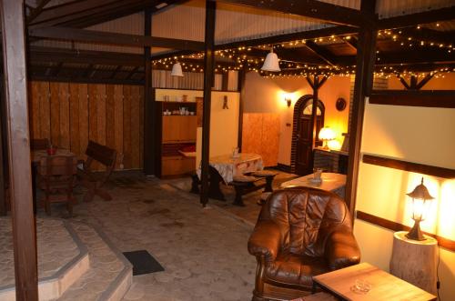 a living room with a leather chair and a table at Apartmány Modus 2 in Česká Ves