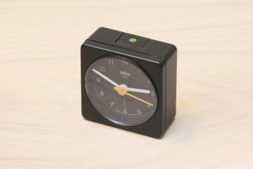 a black clock sitting on top of a table at Center Hotel Tokyo in Tokyo