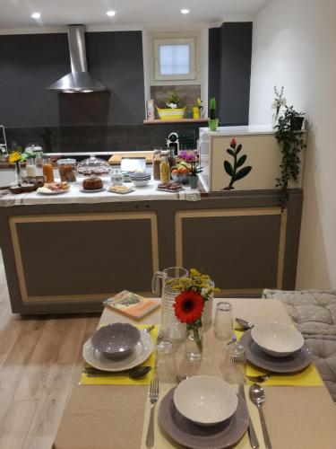 a kitchen with a table with plates and dishes on it at B&B Casa Lilli in Foligno