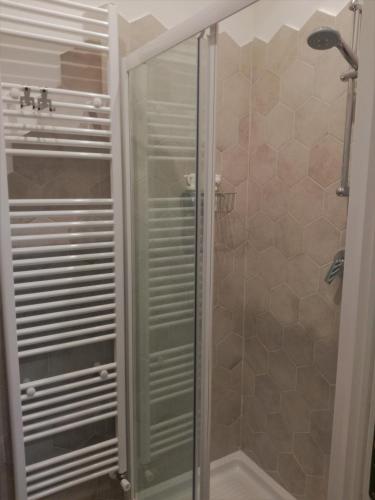 a shower with a glass door in a bathroom at B&B Casa Lilli in Foligno