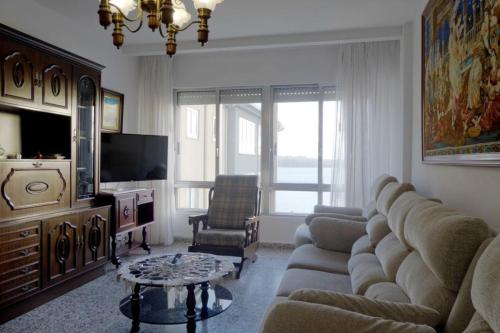 a living room with a couch and a tv at El mirador del mar in Ferrol