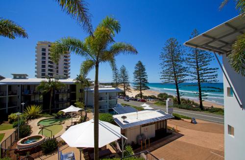 a view of the beach from the balcony of a resort at The Beach Retreat Coolum in Coolum Beach