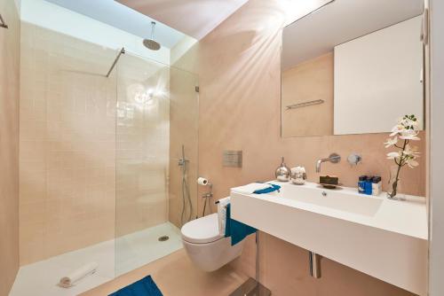 a bathroom with a sink and a toilet and a shower at Casa Portuguesa Ouro in Lisbon