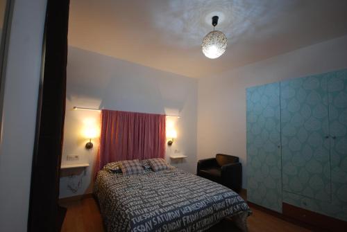 a bedroom with a bed and a window and a lamp at ATICO 2 in La Laguna