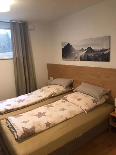 two beds sitting next to each other in a room at Haus Schladming in Schladming
