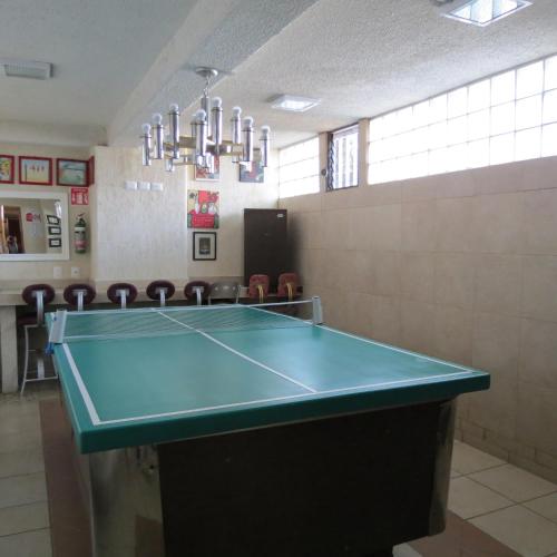 a ping pong table in a room with chairs at Azul Turquesa in Cuernavaca