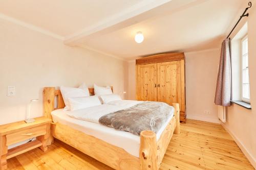 a bedroom with a wooden bed and a window at Ferienhaus Casa Maria in Morbach