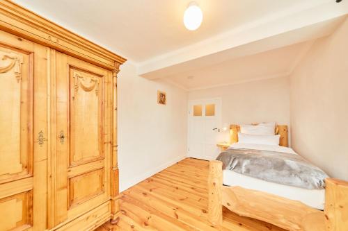 a bedroom with a bed and a wooden cabinet at Ferienhaus Casa Maria in Morbach