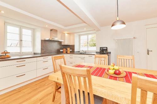 a kitchen with a wooden table with a bowl of fruit on it at Ferienhaus Casa Maria in Morbach