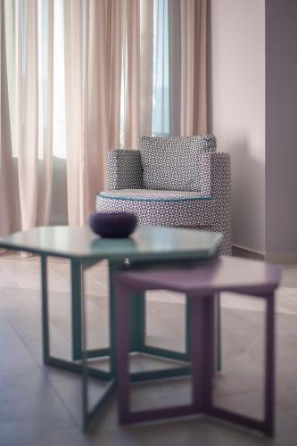 a coffee table with a chair and a couch at Royal Gardens Paradise in Budva