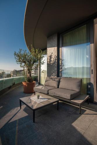 a living room with a couch and a table at Royal Gardens Paradise in Budva