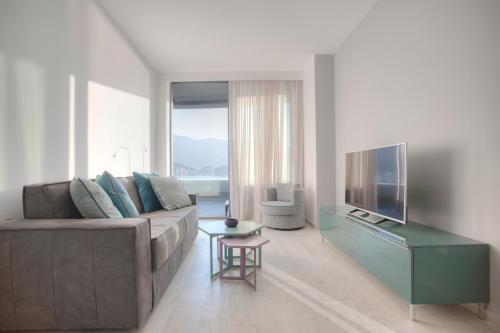a living room with a couch and a television at Royal Gardens Paradise in Budva