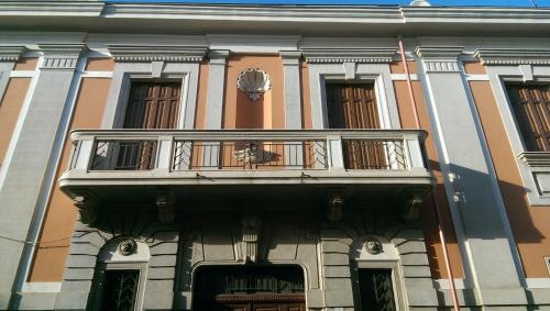 a building with a balcony on top of it at palazzo don Ruggiero in San Ferdinando di Puglia