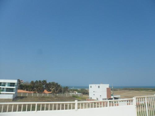 a view of the ocean from the balcony of a building at Cabaña Villa Flower Gold in Juan de Acosta