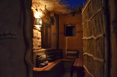 a small room with a couch and a window at Ckuri Atacama in San Pedro de Atacama