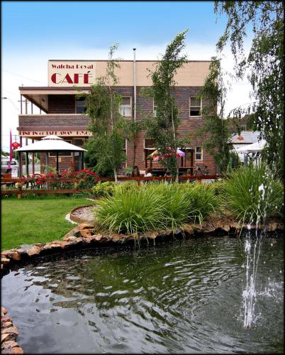 a building with a pond in front of a building at Walcha Royal Cafe & Accommodation in Walcha