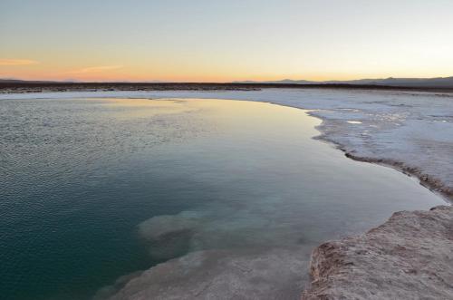 an aerial view of a body of water at sunset at Ckuri Atacama in San Pedro de Atacama