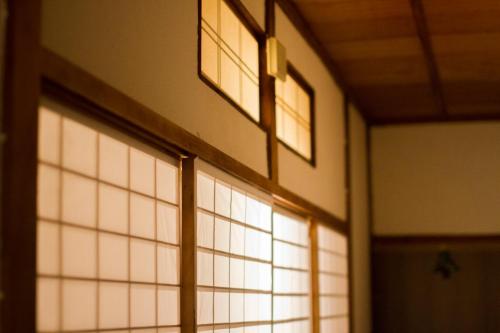 a window in a room with lights on it at Engawa in Tonosho