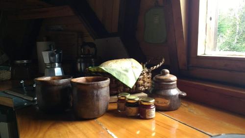 a counter with three buckets and a basket of bread at Domos Puelo in Lago Puelo