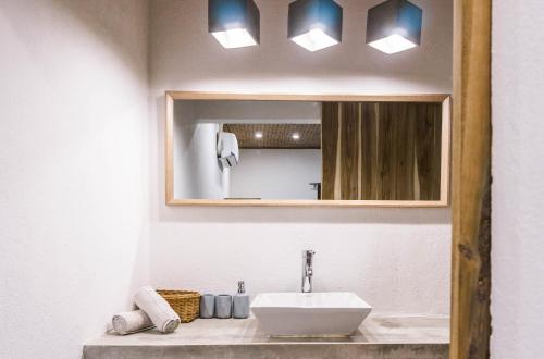 a bathroom with a sink and a mirror at Fisheye The Rooms - Room 2 in El Nido