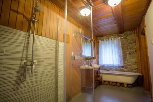a bathroom with a shower and a bath tub at Galexy Lounge in Burkes Pass