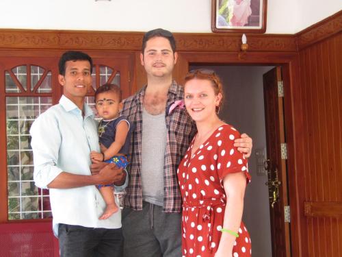 a family posing for a picture in front of a house at EAST STAVANGER in Anaviratty