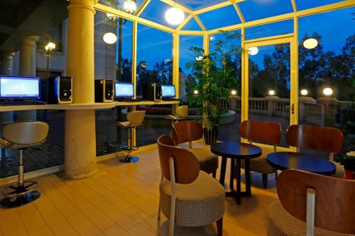 a restaurant with a bar with tables and chairs at Golden Tulip - Aesthetics in Zhunan