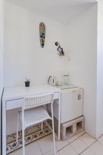 a white desk with a chair in a room at Granny's Inn Hostel in Sliema