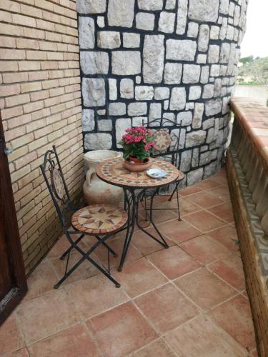 a small table and two chairs on a patio at Castello in Valguarnera Caropepe