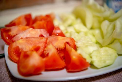 a plate of food with tomatoes and vegetables on a table at Ana Boutique in Alba Iulia