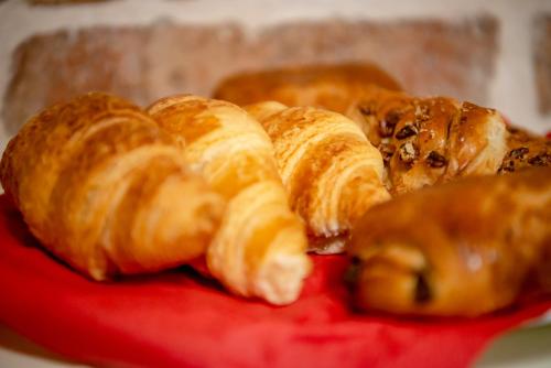 a pile of croissants and other pastries on a red plate at Ana Boutique in Alba Iulia