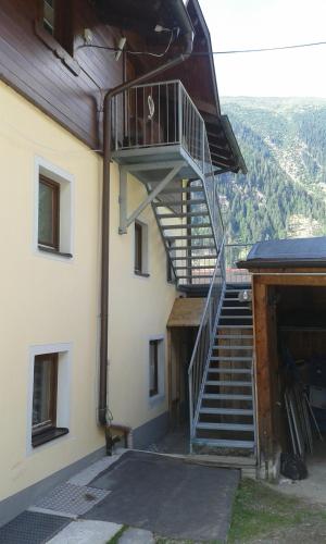 a spiral staircase on the side of a building at Alpin Appart Reiterhof in Niederthai