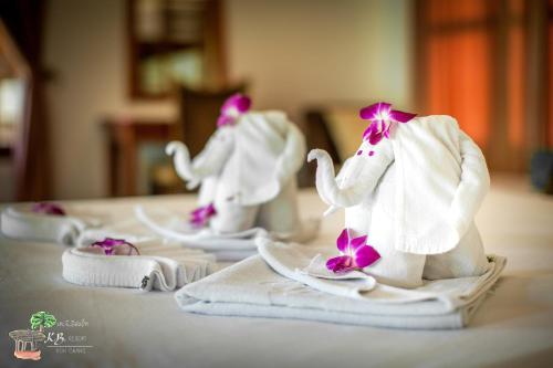 three elephant figurines sitting on towels on a table at K.B. Resort in Ko Chang